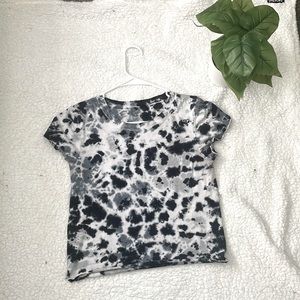 The brand is called urban rebel. It’s a white , grey , and black shirt.